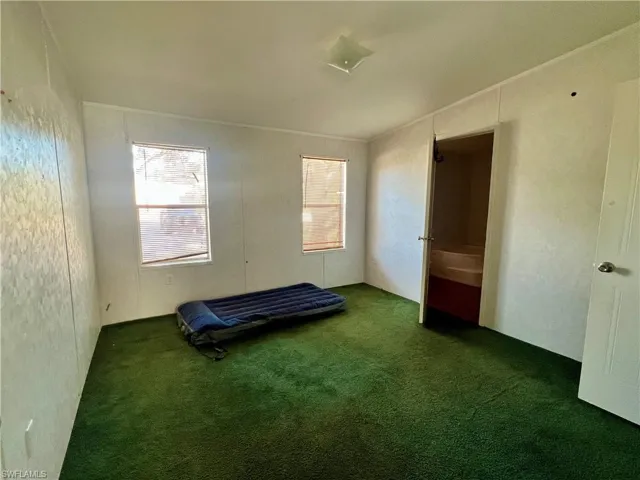 Unfurnished bedroom with carpet
