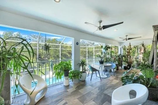 Sunroom / solarium featuring ceiling fan