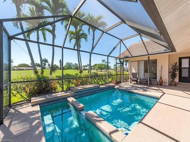 View of pool featuring a pool with connected hot tub, a lanai, and a patio area