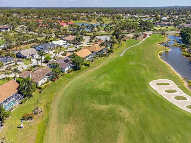 Bird's eye view with a water view, view of golf course, and a residential view