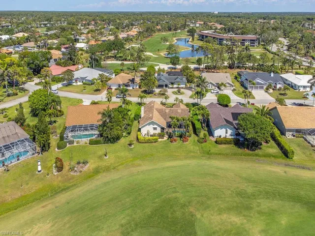 Aerial view featuring view of golf course, a residential view, and a water view