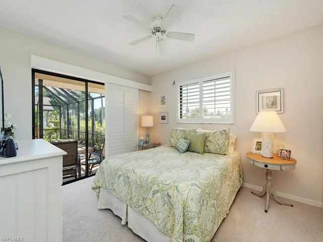 Bedroom with baseboards, ceiling fan, access to outside, and light carpet