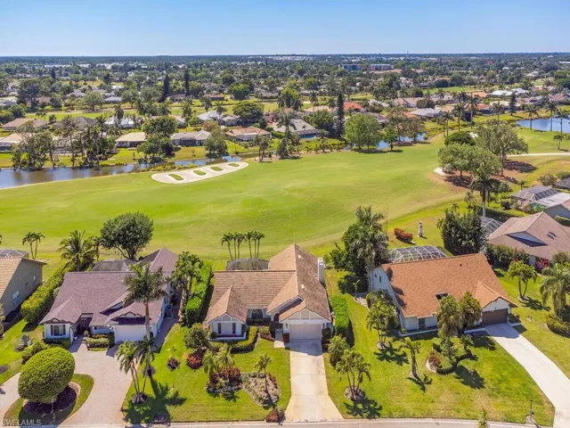 Birds eye view of property featuring a water view, a residential view, and golf course view