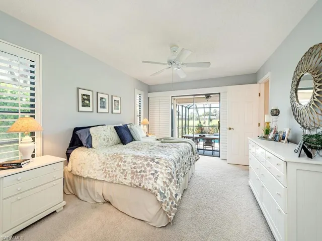 Bedroom featuring light carpet, access to outside, and ceiling fan