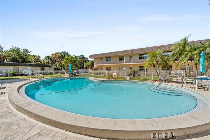 Community pool featuring fence