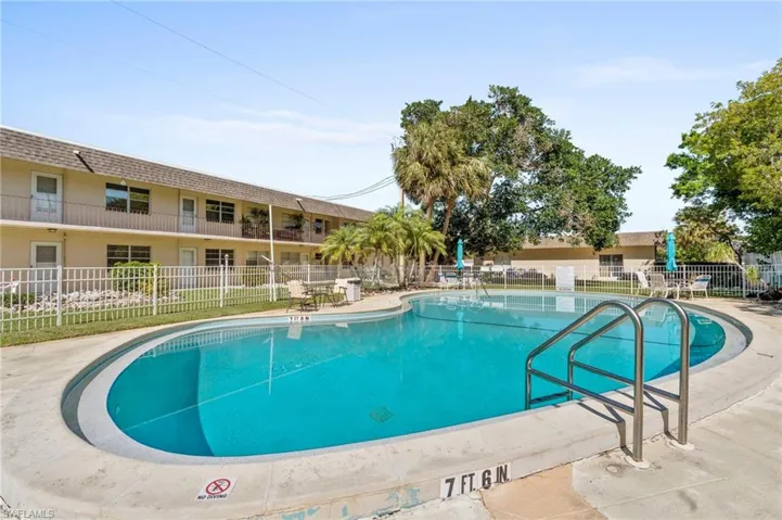 Community pool featuring fence