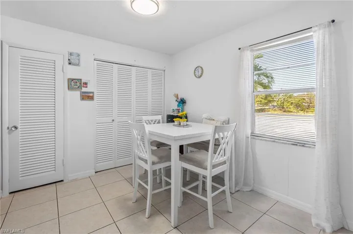 Dining room with baseboards and light tile patterned floors