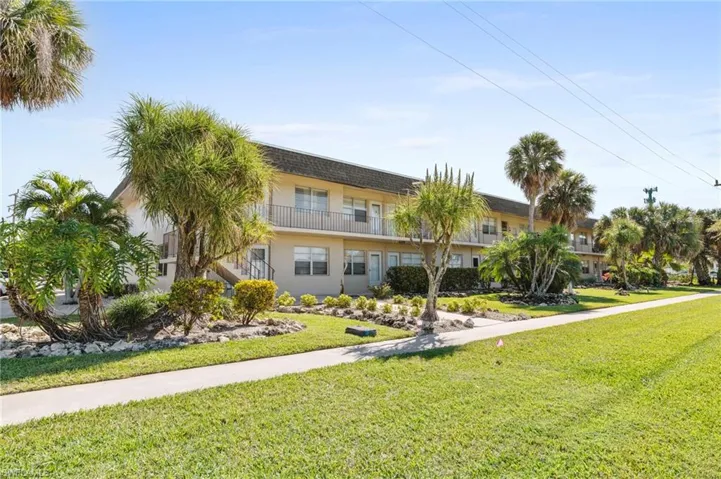 View of front facade featuring a front yard and stucco siding