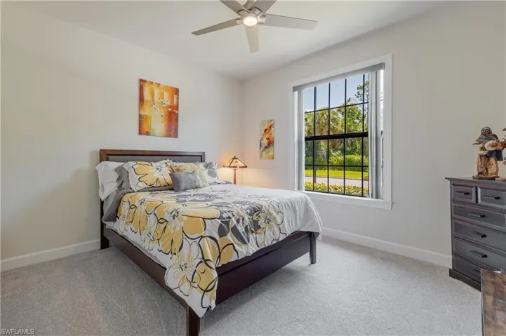 Bedroom featuring ceiling fan and carpet floors
