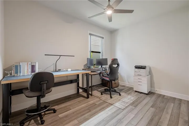 Office with ceiling fan and light wood-type flooring