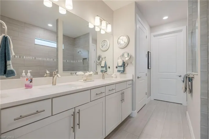 Bathroom with tile floors and double sink vanity