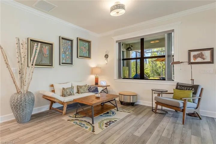 Living room featuring light hardwood / wood-style flooring and crown molding