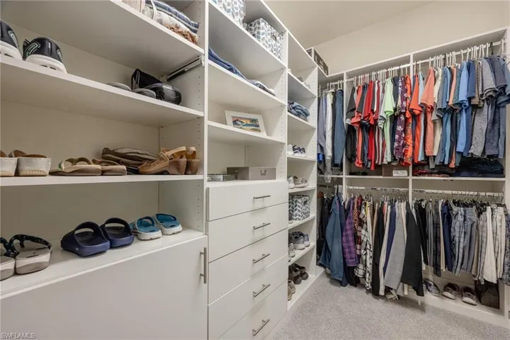 Spacious closet with light colored carpet
