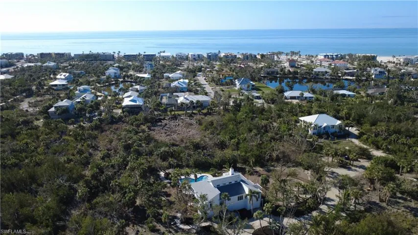 Aerial perspective of suburban area featuring a large body of water