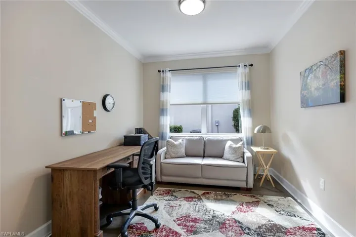 Office area featuring hardwood / wood-style floors and ornamental molding