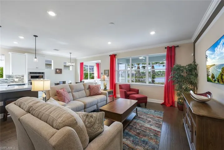 Living room with crown molding and dark hardwood / wood-style floors