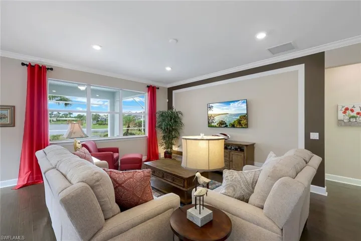Living room featuring dark hardwood / wood-style floors and ornamental molding