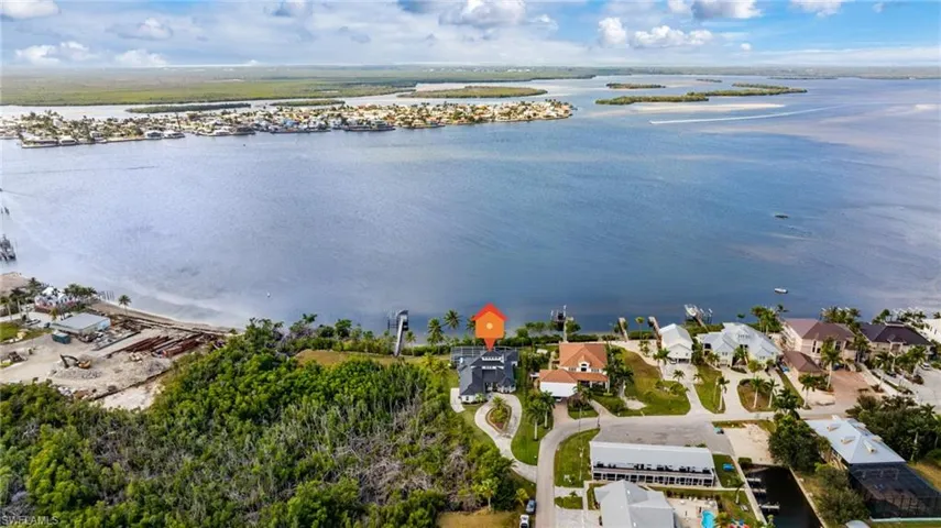 Aerial perspective of suburban area featuring a large body of water