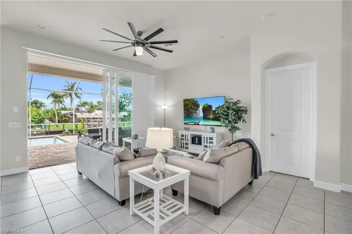 Tiled living room featuring ceiling fan