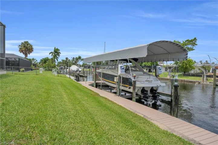 View of dock featuring a water view and a yard