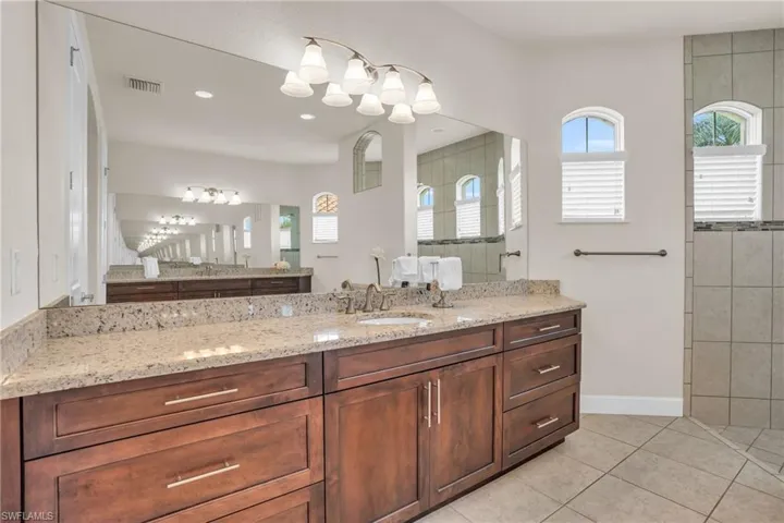 Bathroom featuring tile flooring and vanity with extensive cabinet space