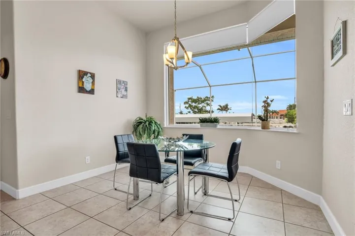 Tiled dining space with a notable chandelier