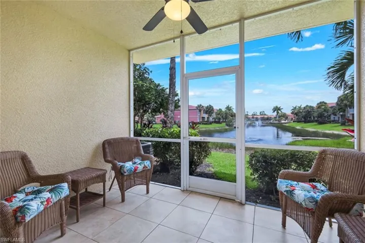 Screened lanai featuring large format tile flooring and a ceiling fan