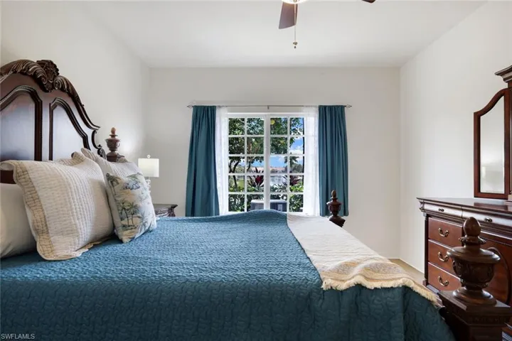 Window featuring white grid panes and blue fabric drapes