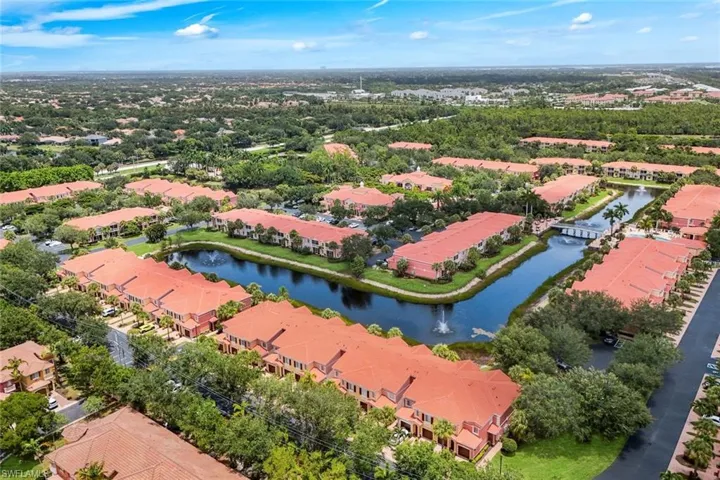Aerial perspective highlighting a community with terracotta-style rooflines and lush landscaping