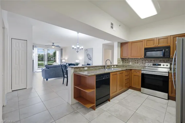 Kitchen featuring wood cabinetry, granite countertops, and stainless steel appliances