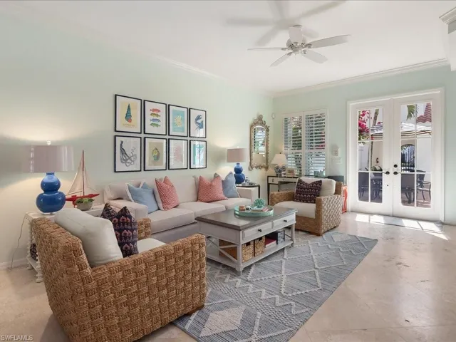 Living area featuring crown molding, french doors, and ceiling fan