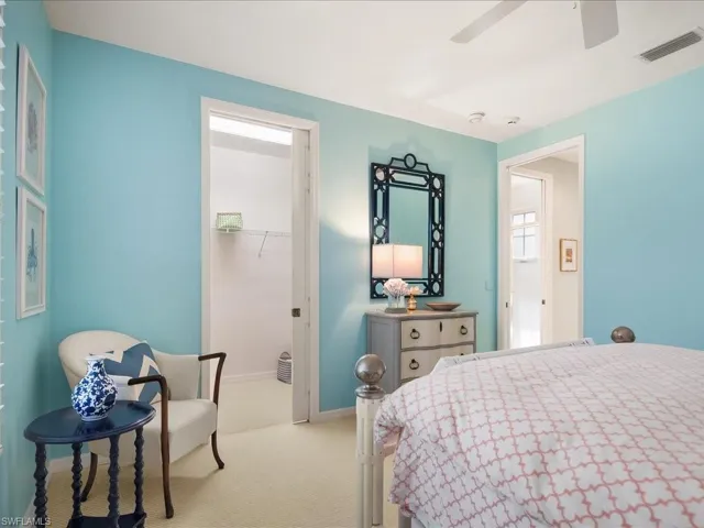 Bedroom with a spacious closet, carpet floors, and ceiling fan