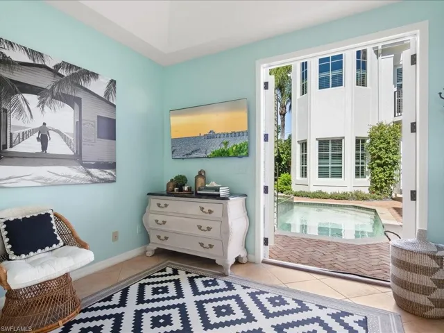 Living area featuring light tile patterned floors and baseboards