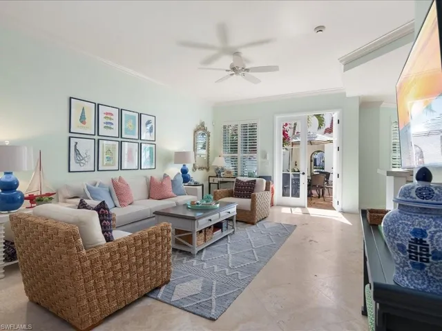 Living room featuring ornamental molding, ceiling fan, and french doors