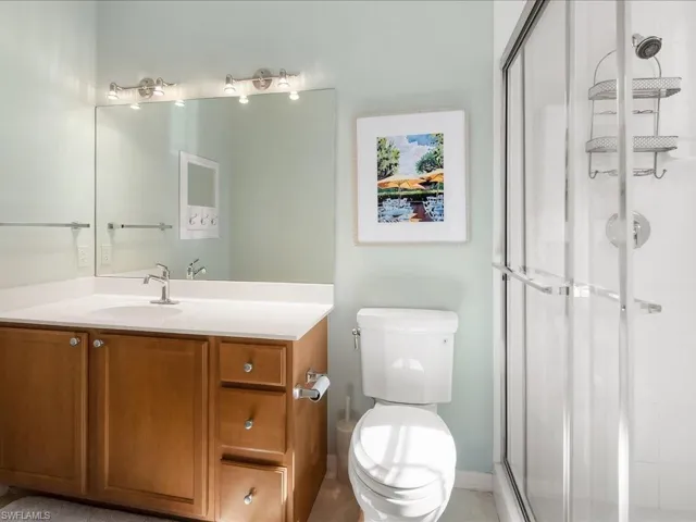 Full bath with a shower stall and vanity