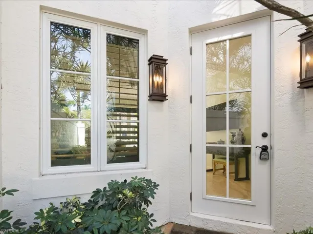 Entrance to property with stucco siding