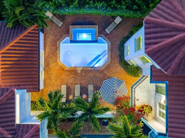 Aerial view of property and surrounding area featuring a pool area