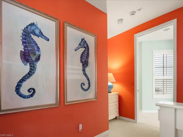 Hallway with carpet floors and baseboards