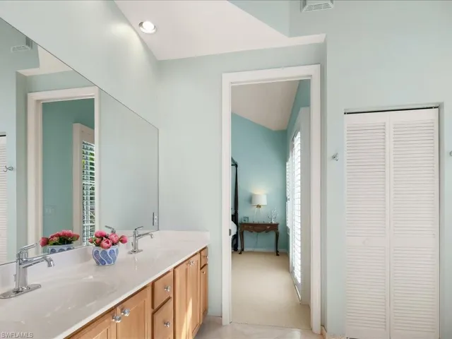 Full bath featuring a closet, double vanity, and ensuite bathroom