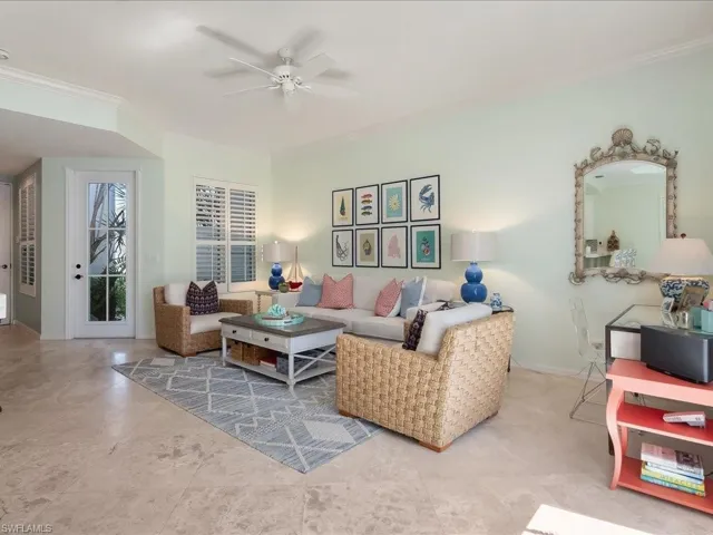 Living area featuring ornamental molding and ceiling fan