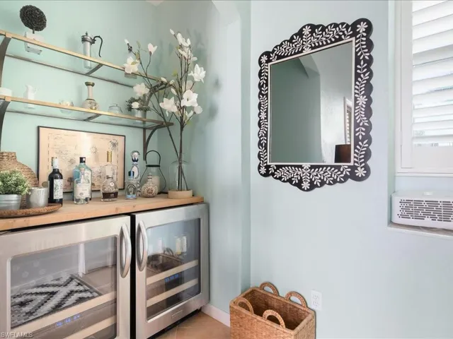 Bar area featuring wine cooler and open shelves
