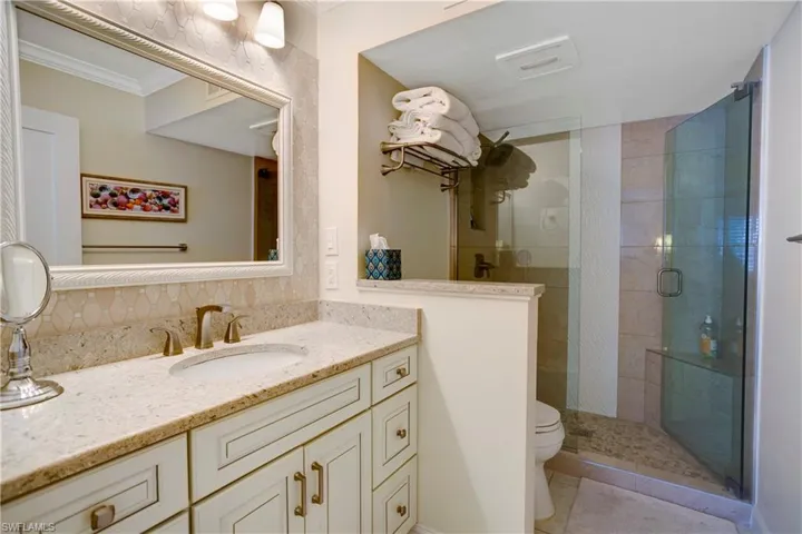 Heavy glass shower door, custom tile in shower, new vanity, lighting, & fixtures.