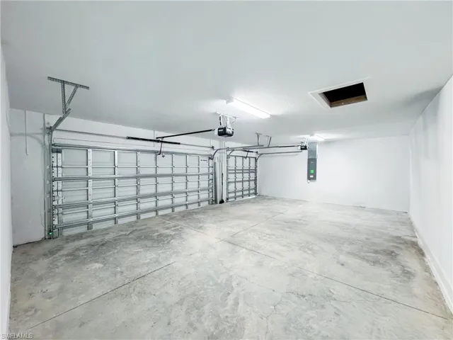 Garage with electric panel and a garage door opener