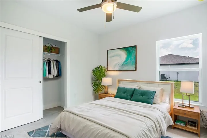Tiled bedroom featuring a ceiling fan, a closet, and baseboards