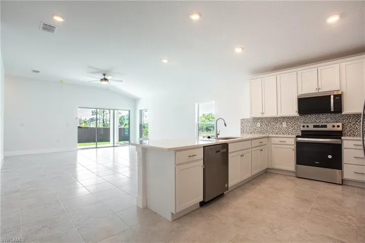 Kitchen featuring a sink, plenty of natural light, a ceiling fan, and stainless steel appliances