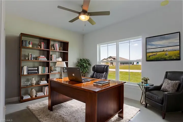 Office featuring finished concrete floors and ceiling fan