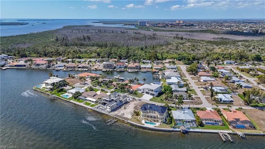 Aerial perspective of suburban area with a nearby body of water