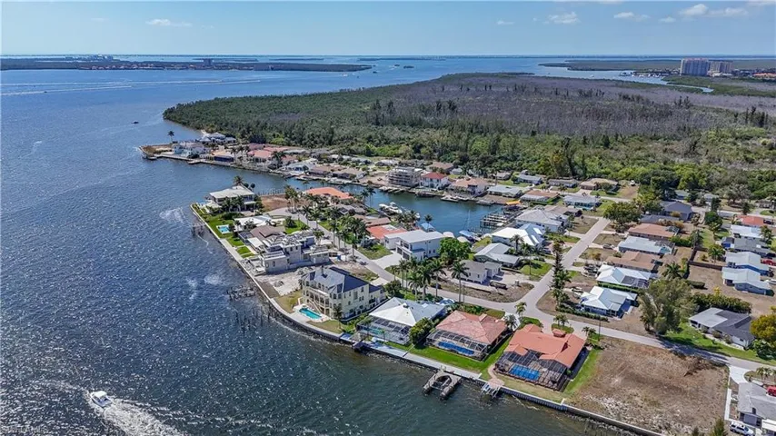 Aerial perspective of suburban area featuring a nearby body of water
