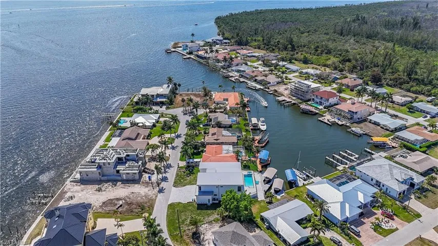 Aerial view of property and surrounding area with nearby suburban area and a nearby body of water