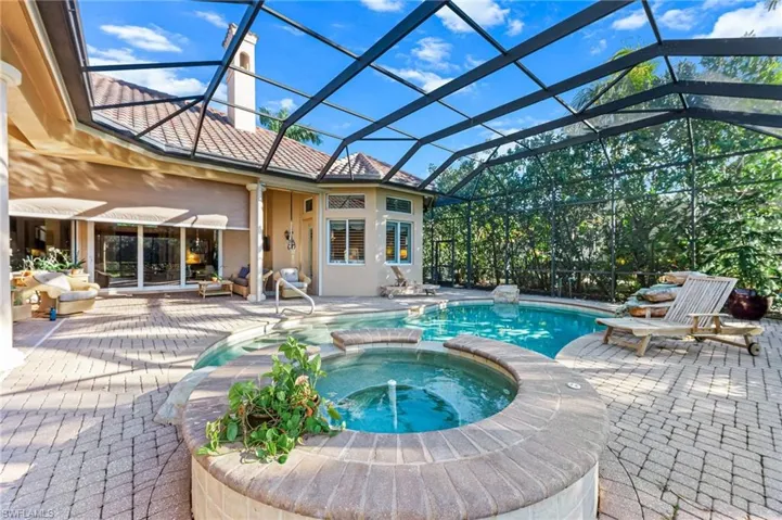 Integrated pool / hot tub featuring a sunroom, a patio area, and a lanai